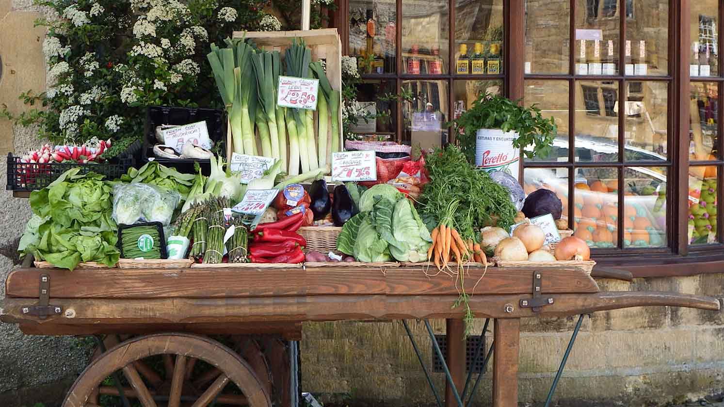 Fresh vegetables on a cart outside a farm shop
