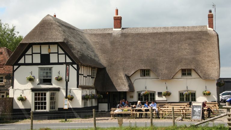 Half timbered 17th century pub with a thatched roof