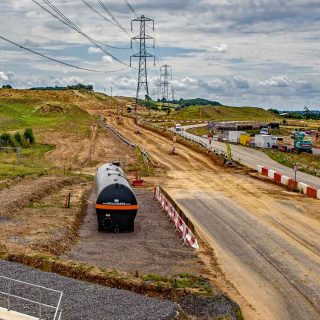 (131) Looking south along the access road towards construction of fuel storage depot - Jul. 2023 (18_153)