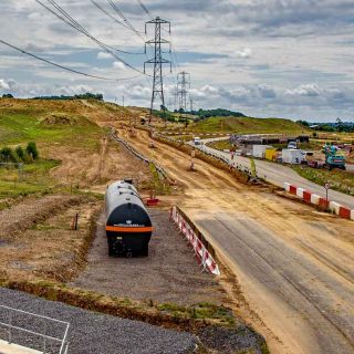 (131) Looking south along the access road towards construction of fuel storage depot - Jul. 2023 (18_153)